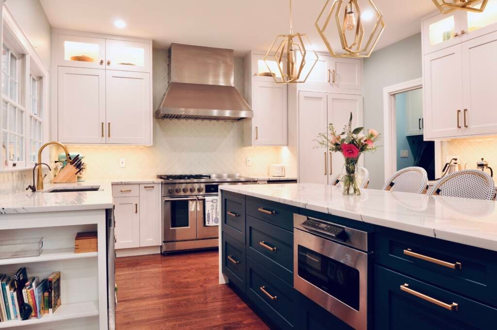 Remodeled white kitchen with a marble waterfall island